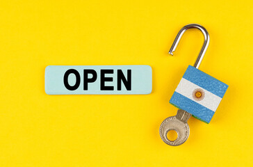 Poster - On the yellow surface is an open lock with a key and a sticker with the inscription - open