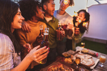 night party rooftop multiracial group beers