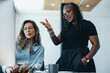 © Jacob Lund - Mature black business woman having a discussion with her colleague in front of a computer