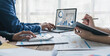 © wichayada - Business People Meeting using laptop computer,calculator,notebook,stock market chart paper for analysis Plans to improve quality next month. Conference Discussion Corporate Concept..