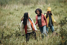 Smiling Female Friends Hiking In Nature
