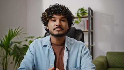 Hindu male teacher talks with students via video conference