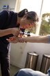 © Austockphoto - Female healthcare worker using a dermatoscope to check female patient's skin on the arms