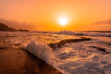 Waves at sunset in the natural pools of La Maceta in El Hierro, Canary Islands