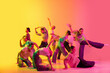 © Lustre Art Group  - School girls wearing white clothes dancing together on pink and yellow gradient background in neon light. Choreography figures