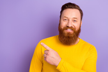 Wall Mural - Portrait photo of young promoter masculine guy wear yellow trendy shirt direct finger mockup new store prices isolated on violet background