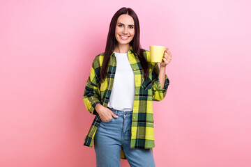 Sticker - Photo of lovely nice girl with straight hairstyle wear checkered shirt arm in pocket hold mug of coffee isolated on pink color background