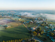 © Austockphoto - Aerial view of mist over landscape of small farm paddocks and roads through rural town at dawn