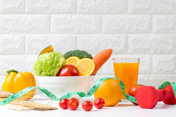 Wall Mural - Diet and healthy fresh vegetable fruits for detox body slim fit for health lifestyle with Sport exercise equipment workout and orange juice,  white background. Weight Loss and Diet Concept