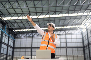 Manager visit interior of empty huge distribution warehouse. 