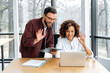 © Kateryna - Successful coworkers of different nationalities, a man and a woman, working together, discuss business goals and ideas for new project with partners by video call, smile. Online video conversation