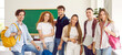 © Studio Romantic - Students pose for a photo in a bright modern classroom.Beautiful three girls and three young men of self-confident students posing for a group photo.Everyone smiles and sets a good positive attitude.