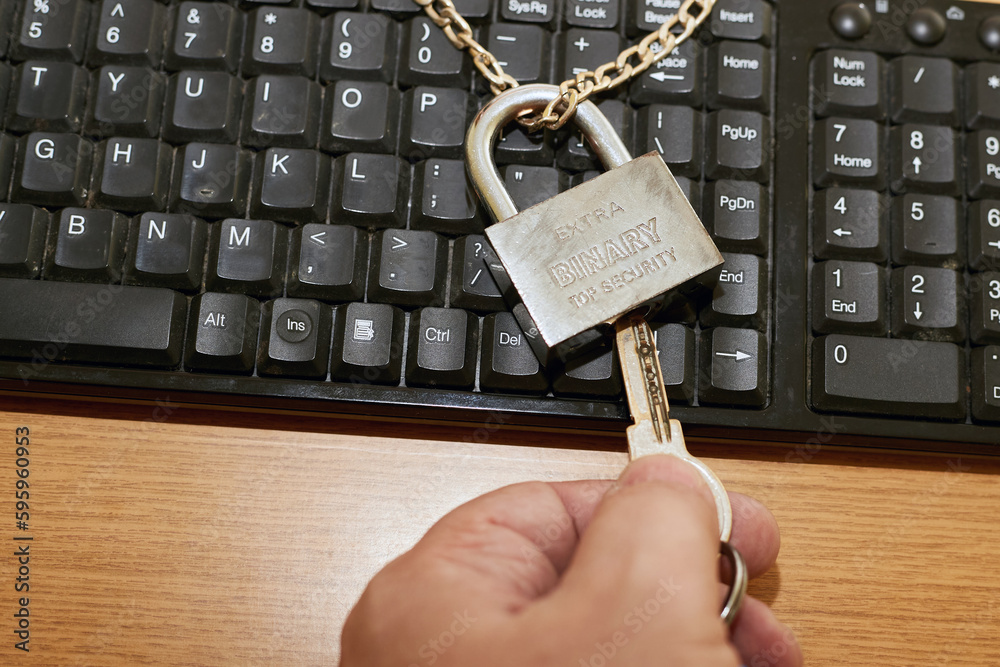 Computer With Lock On Keyboard Photo Stock Hand with key opens symbolic lock on computer keyboard. The ...