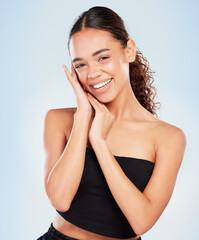 Poster - Shes got the perfect glow. a young woman posing against a blue background.