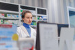© Halfpoint - Portrait of young pharmacist selling medication in pharmacy.