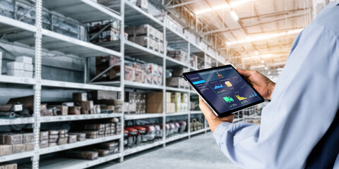 Wall Mural - Smart Warehouse,Inventory management system concept.Manager using digital tablet,showing warehouse software management dashboard on blurred warehouse as background