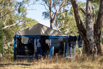 camper trailer set up in the  australian bush, campsite with clothes line