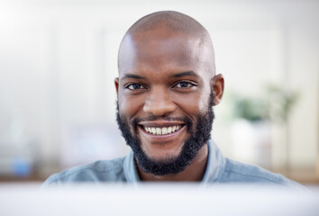 Aufkleber - The starting point of all achievement is desire. a young businessman using a laptop in a modern office.