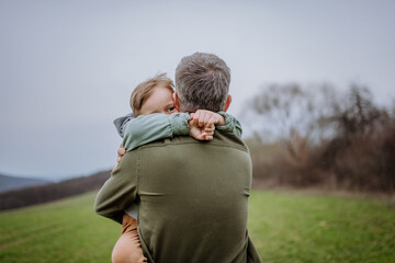 Father and his little son on a walk in nature.