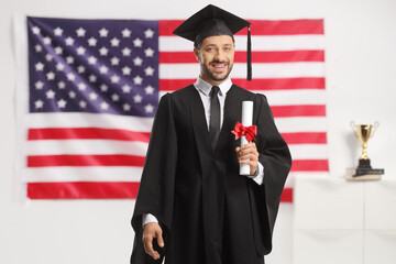 Canvas Print - Bachelor graduate student posing in front of a USA flag