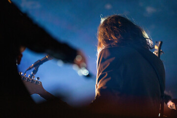 Canvas Print - Band playing music and a gig in a venue, close up of a rock band playing guitars and instruments.