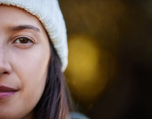 Canvas Print - The eye tells stories the mouth never will. an attractive young woman standing alone outside.