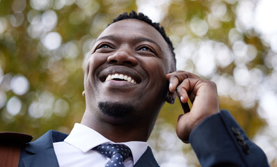 Canvas Print - Starting the morning off with a business call. a young businessman using a phone in the city.