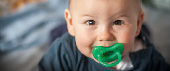 Wall Mural - Portrait of cute happy baby boy looking at camera. Joy and happiness concept. Love and family emotion