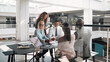 © Flamingo Images - Smiling businesspeople having a meeting in an office lounge area