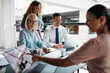 © Flamingo Images - Smiling businesspeople having a meeting in an office building lounge