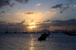 Sunset panorama at the beach of Saint Anne in the south of french overseas island Martinique. Sailing boats anchoring in the bay near “Le Marin“, a popular spot for yachtsmen in the Caribbean sea.