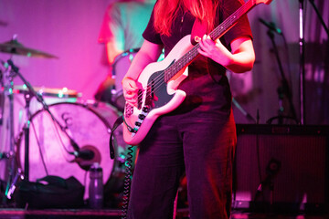 Wall Mural - Band playing music and a gig in a venue, close up of a rock band playing guitars and instruments.