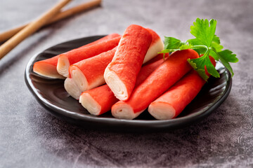 Wall Mural - Fresh crab sticks on black plate