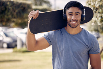 Poster - Its a skaters world and were all living in it. a young man using headphones while skating outside at college.