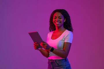 Poster - Digital Leisure. Happy Black Woman With Tablet Computer Posing In Neon Light