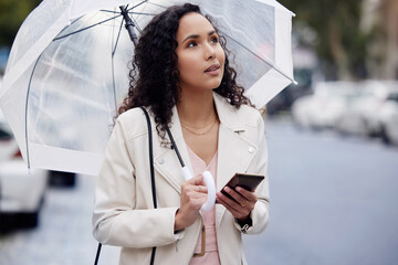 Wall Mural - Dont get caught up in unfamiliar streets. a young woman looking lost while holding an umbrella and walking in the city.