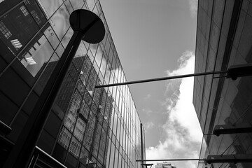 Poster - reflection of the clouds in the glass facade of a modern building