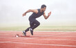 © Nina Lawrenson/peopleimages.com - The race is on. Full length shot of a handsome young male athlete running on an outdoor track.