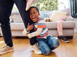 © Nina Lawrenson/peopleimages.com - Hes having a bad day. a little boy throwing a tantrum while holding his parents leg at home.