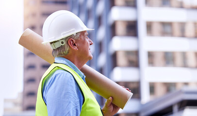 Aufkleber - Planning ahead. a handsome mature male construction worker carrying blueprints while standing outside.