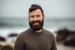 Pet portrait photography of a grinning man in his 30s wearing a cozy sweater against a beach background. Generative AI
