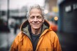 Portrait of a senior man in a raincoat in the city
