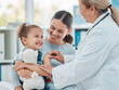 © Nina Lawrenson/peopleimages.com - Shes not afraid to get her routine vaccine. a doctor using a cotton ball on a little girls arm while administering an injection in a clinic.