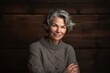 © Robert MEYNER - Portrait of a beautiful senior woman with grey hair on a wooden background