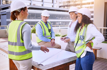 Aufkleber - Communication is important in the construction industry. a group of construction workers looking over building plans while standing on site outside.