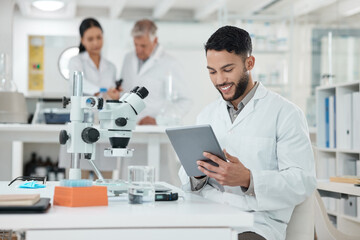 Poster - Writing up a quick summary in digital form. a young scientist using a digital tablet while working in a lab.