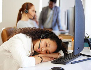 Sticker - Now you know why nobody is answering your call. a young call centre agent sleeping at her desk in an office with her colleagues in the background.