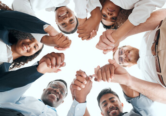 Poster - We stand together as a team. a group of businesspeople holding hands in an office at work.