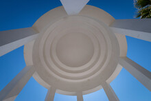 Low Angle View Inside Dome Of A White Rotunda Against Blue Sky