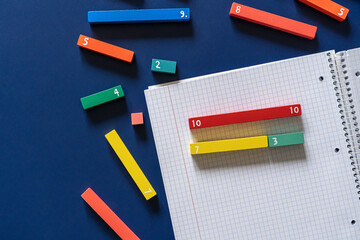 Wall Mural - School stationery, fractions on blue background. Back to school, fun education concept. Set of supplies for mathematics and for school. Close up